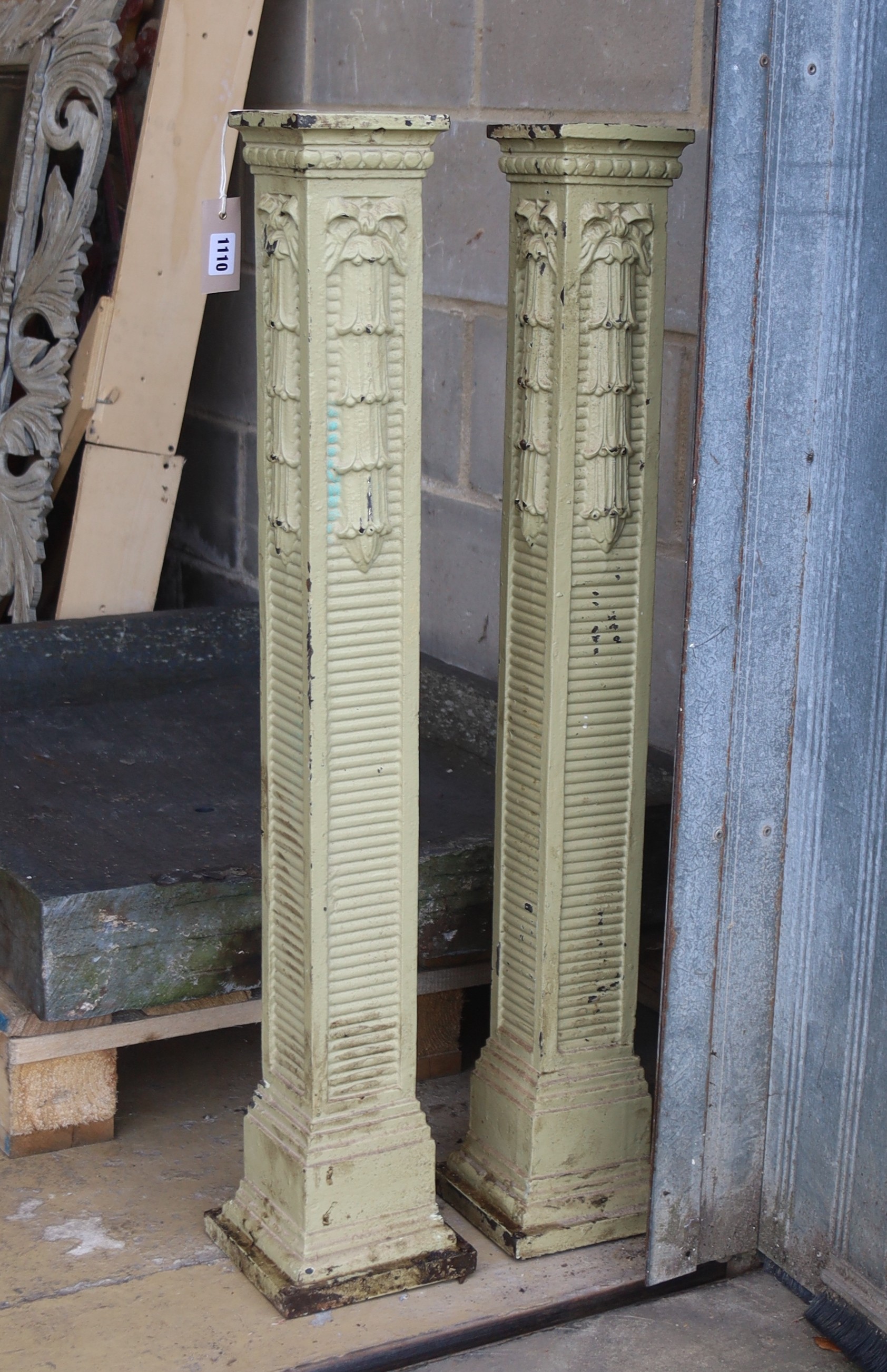 A pair of painted cast iron columns, height 90cm